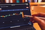 a person using a laptop computer with a chart on the screen