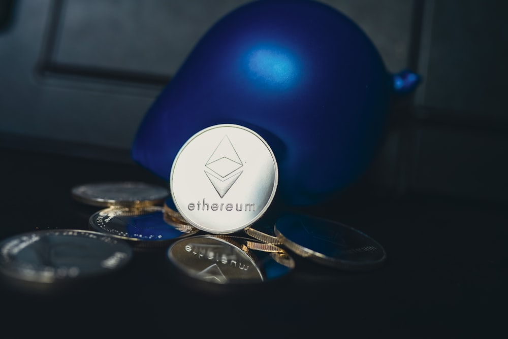 a blue ball sitting on top of a pile of coins