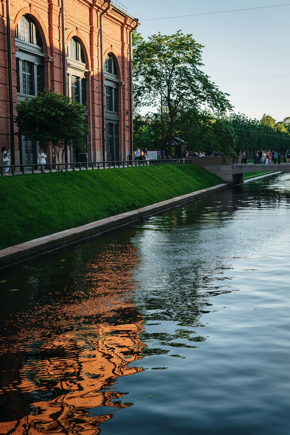 a body of water next to a brick building