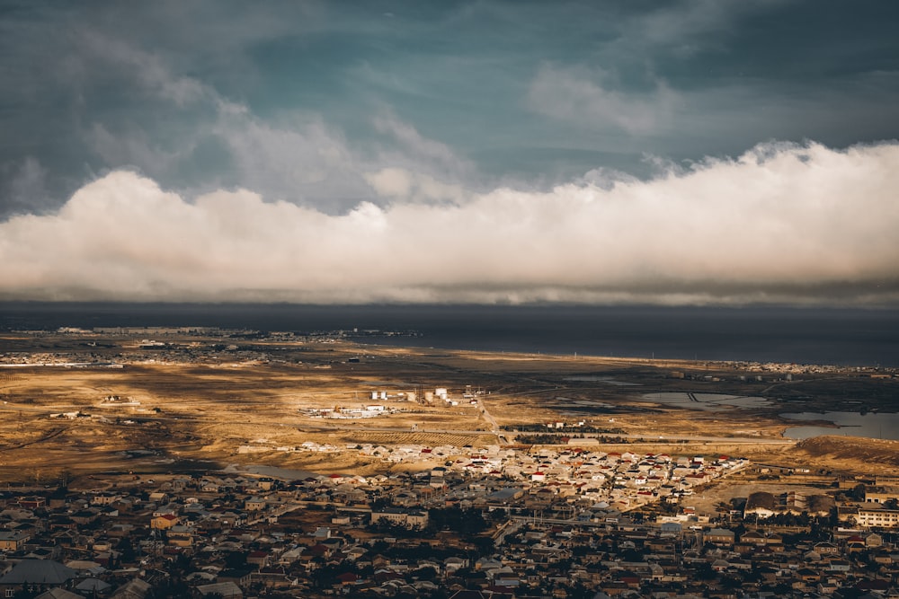 an aerial view of a city under a cloudy sky