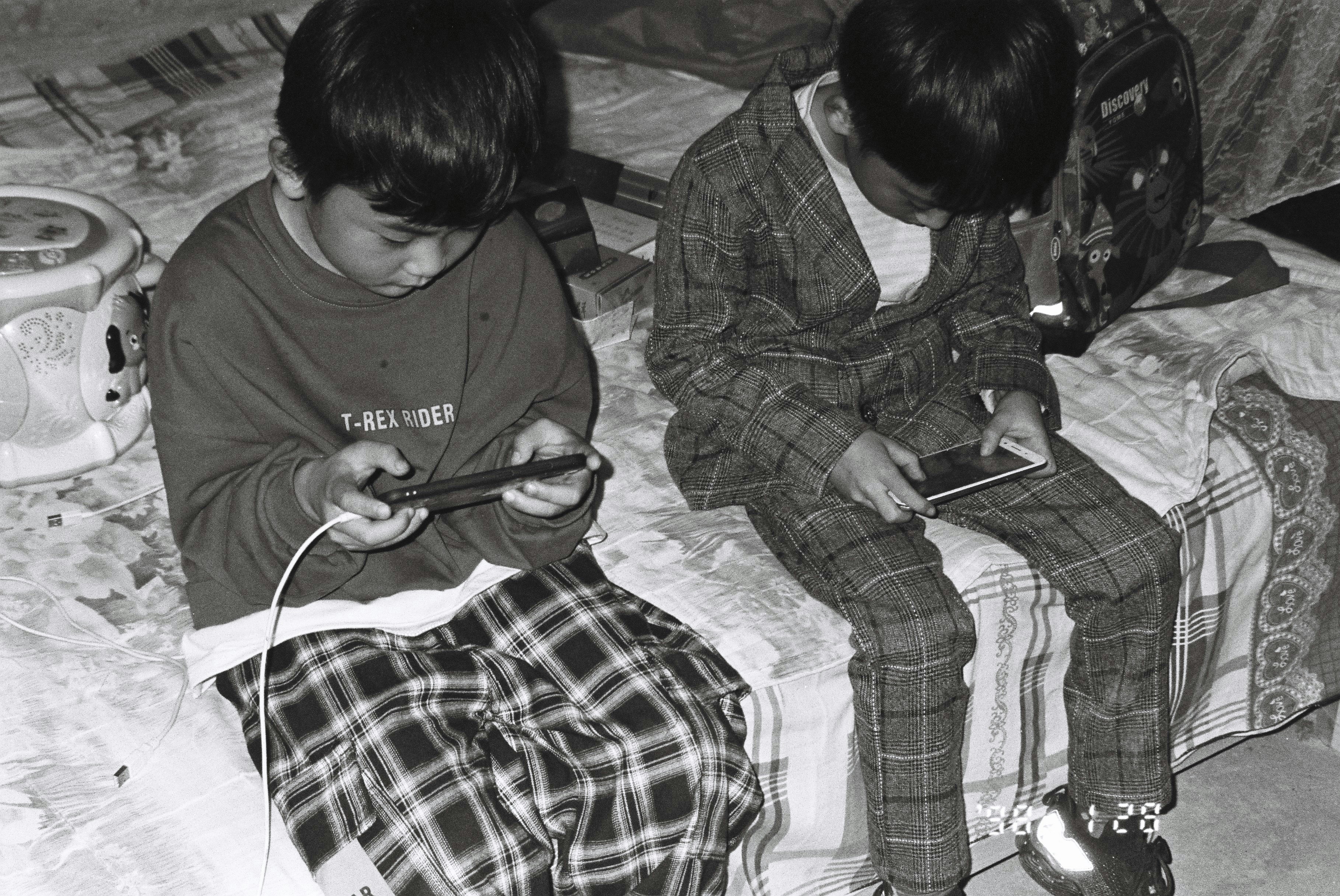 Kids playing on bed