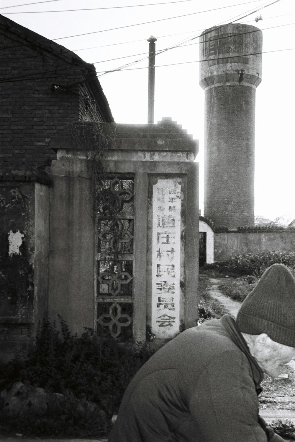 a man kneeling down in front of a building