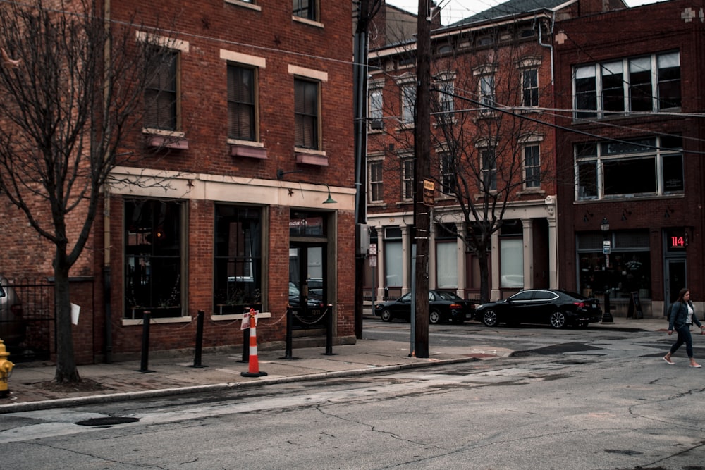 a man walking down a street next to a yellow fire hydrant