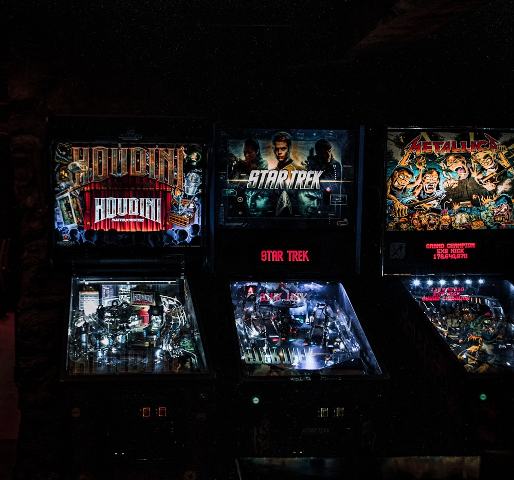 a row of pinball machines sitting next to each other