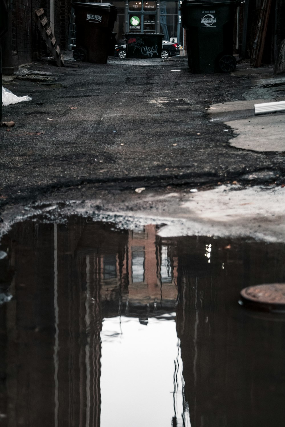 a city street with a puddle of water