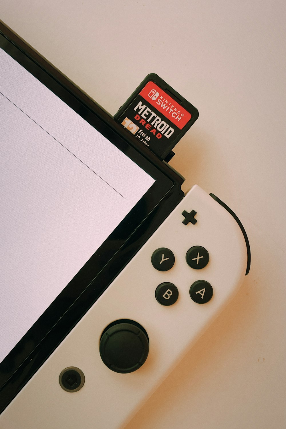 a video game controller sitting next to a computer monitor