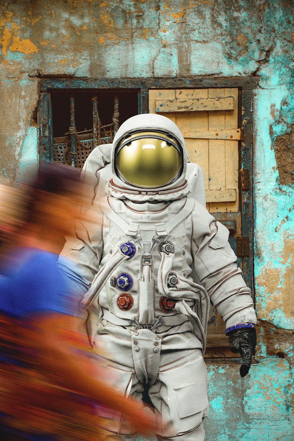a man in a space suit walking past a building