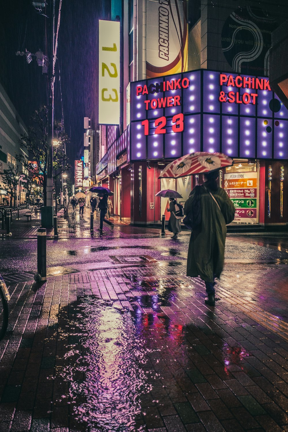 a person walking down a street holding an umbrella