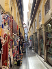 A narrow, winding street in the old Medina filled with artisan shops and lanterns.
