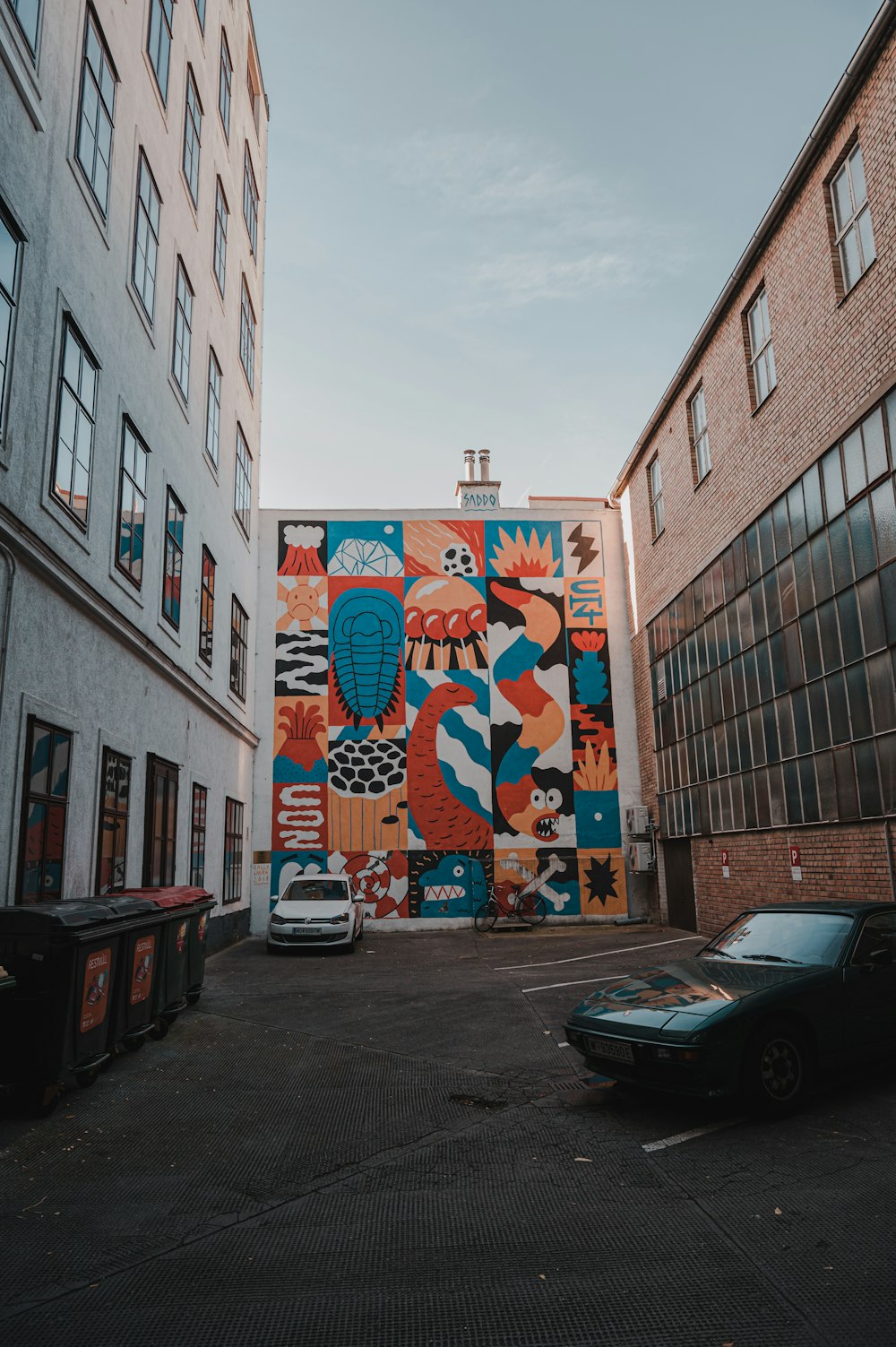 a mural on the side of a building in a parking lot