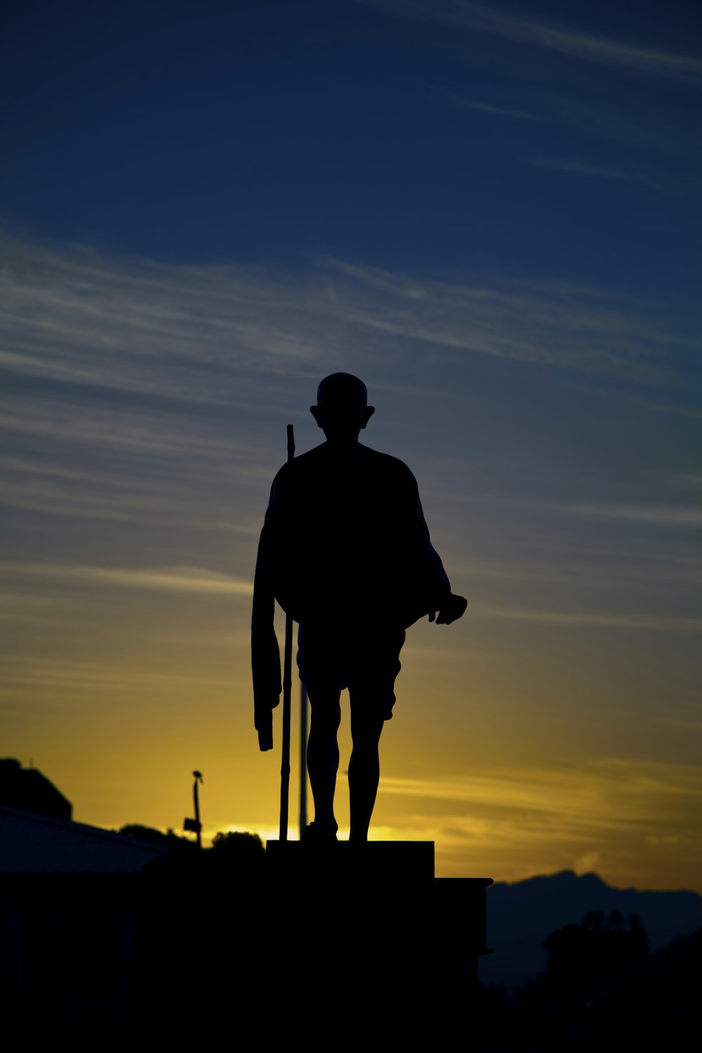 a silhouette of a man holding a baseball bat