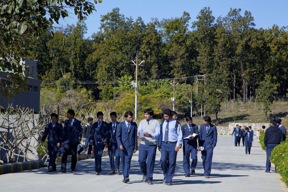 a group of men in suits walking down a street