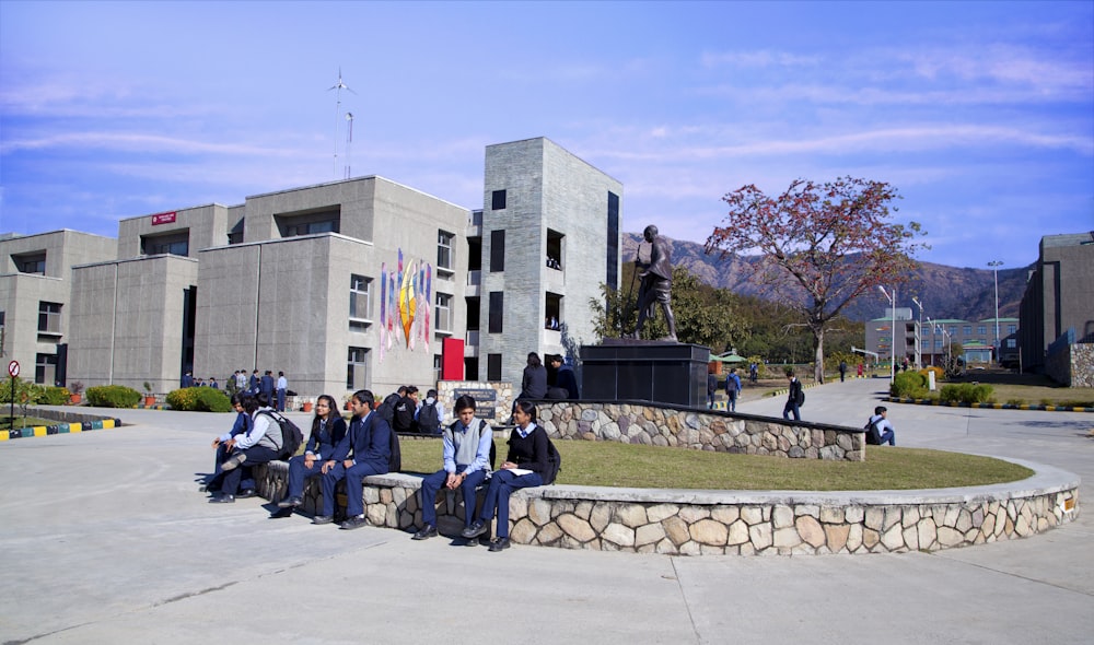 a group of people sitting in front of a building