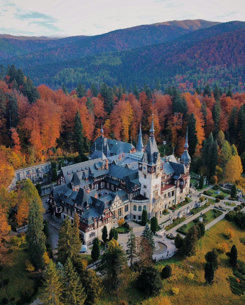 an aerial view of a castle surrounded by trees