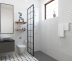 a bathroom with a toilet, sink, and shower