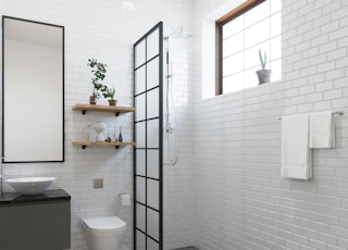a bathroom with a toilet, sink, and shower