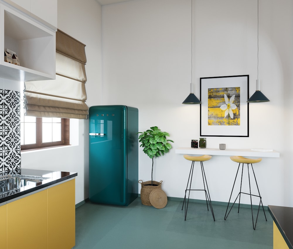 a kitchen with a blue refrigerator and yellow stools