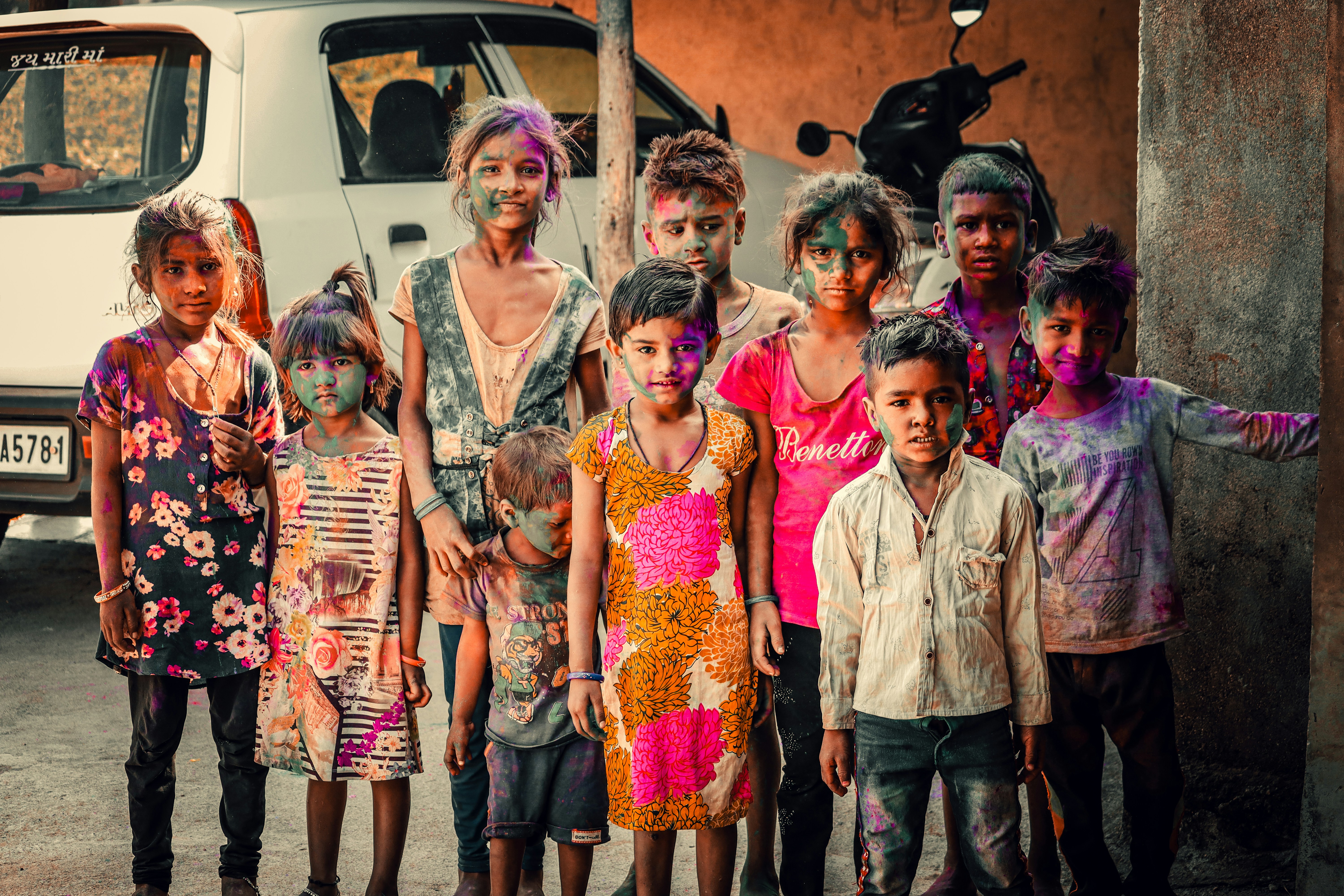 a group of children standing in front of a van