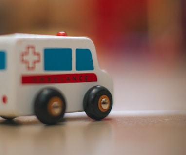 a toy ambulance is sitting on the floor