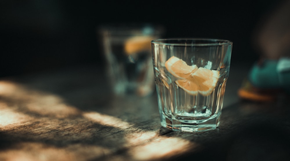 a glass of water with orange peels in it