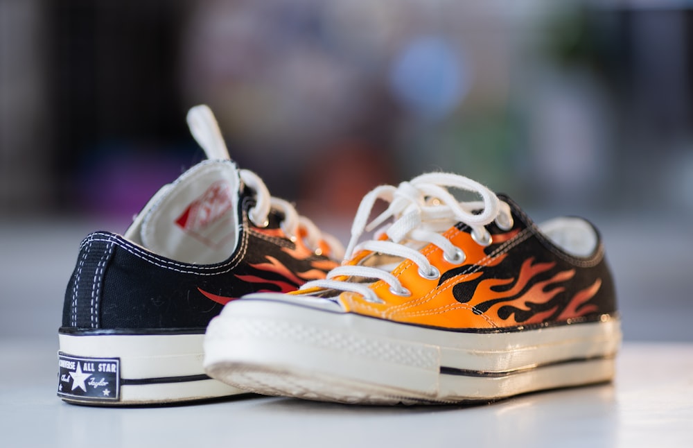 a pair of shoes with flames painted on them