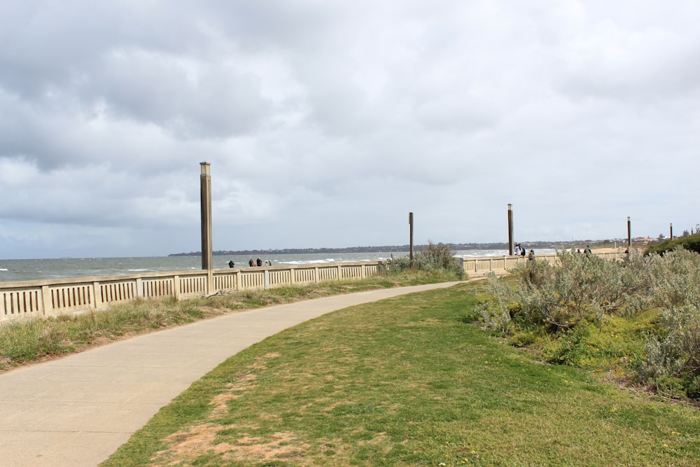 a path next to the beach leading to the ocean