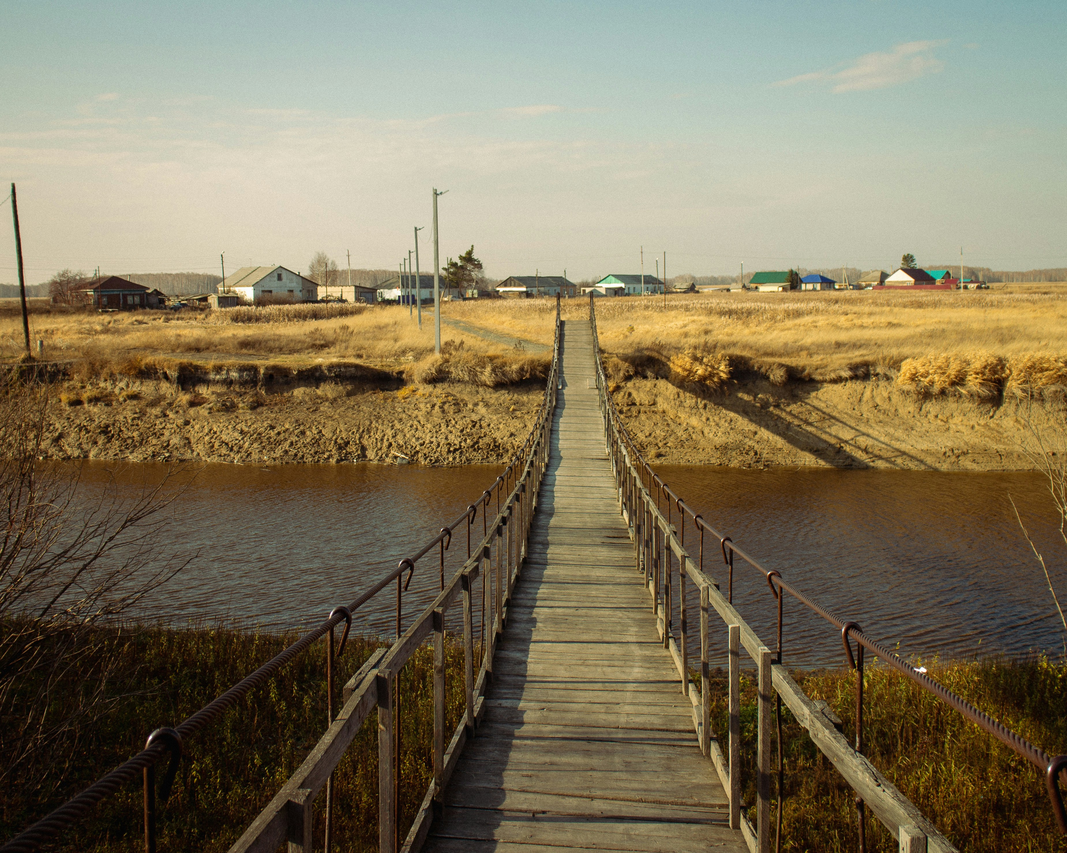 a wooden walkway leading to a body of water