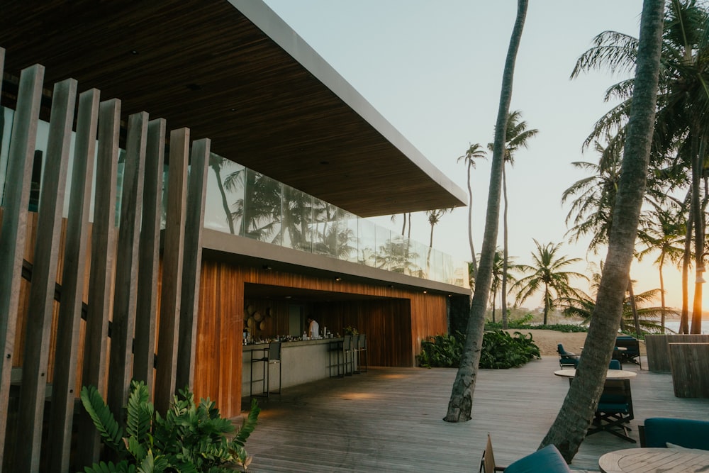 a wooden deck with a bar and palm trees