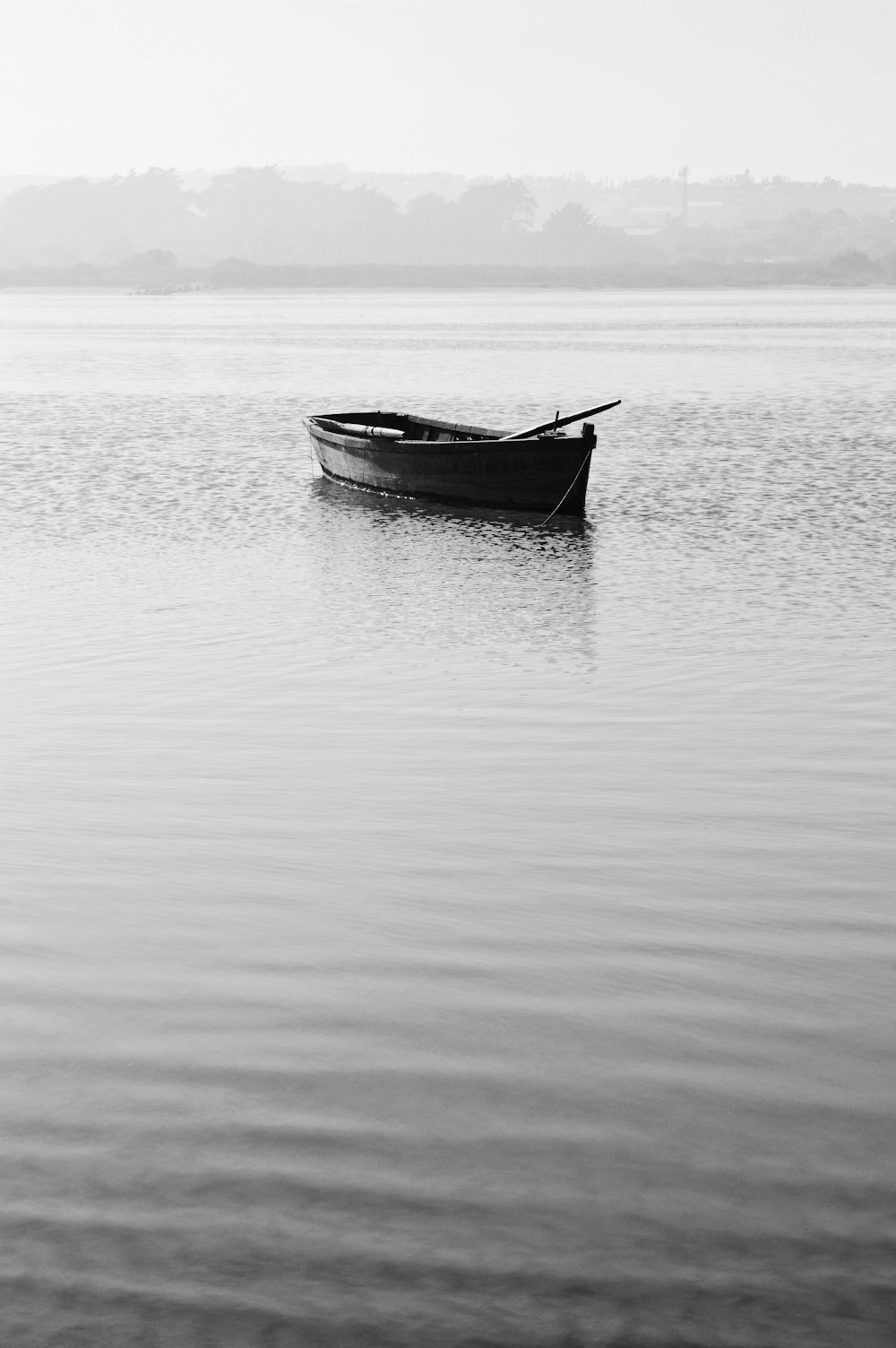 a small boat floating on top of a large body of water