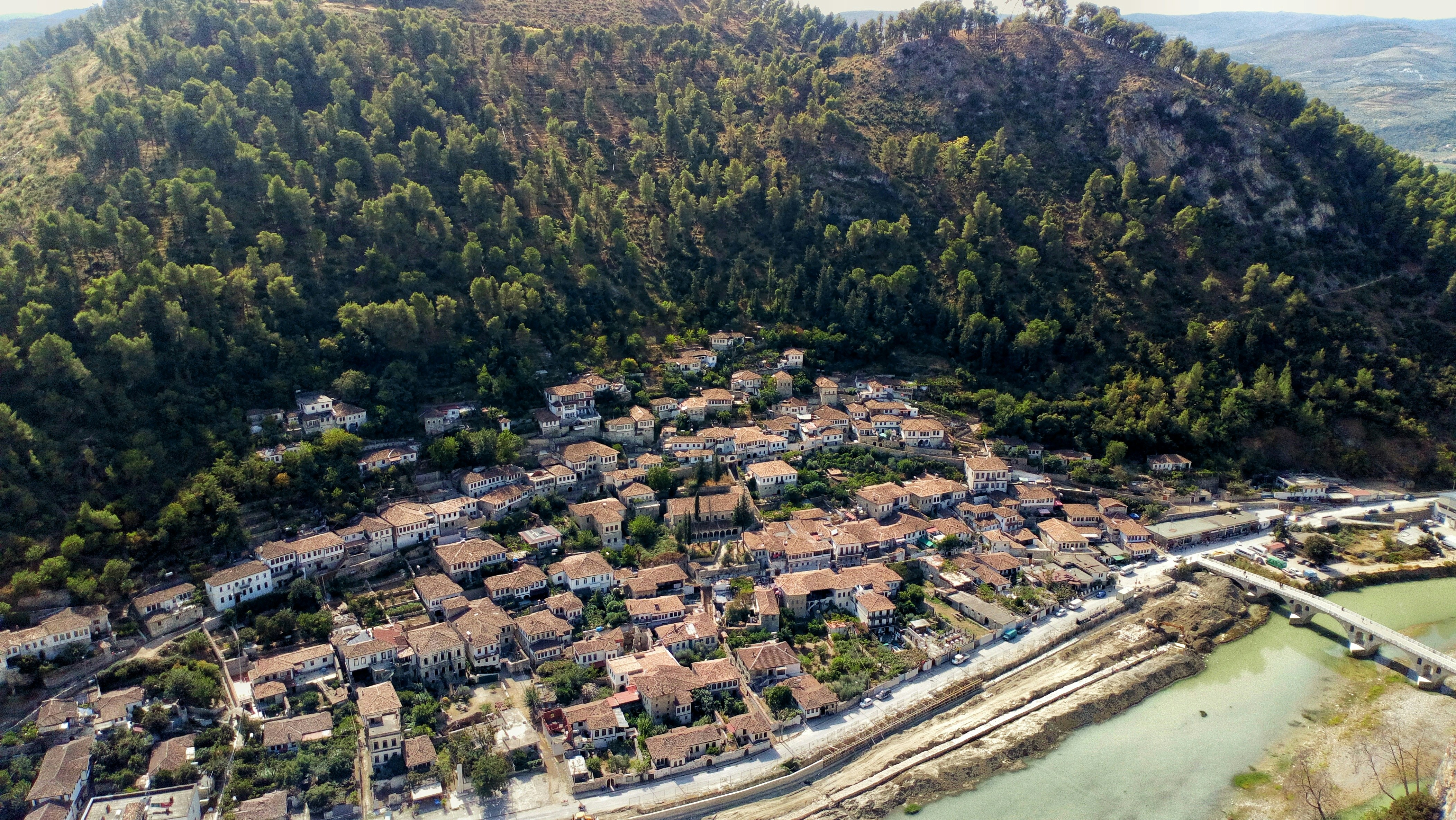 Image of a scenic road connecting Albanian towns with lush greenery in the background