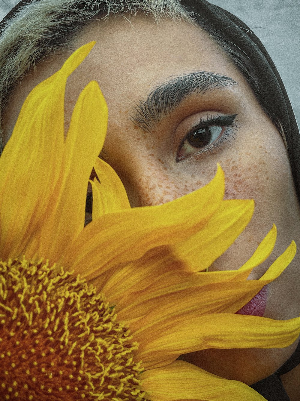 a close up of a person with a sunflower