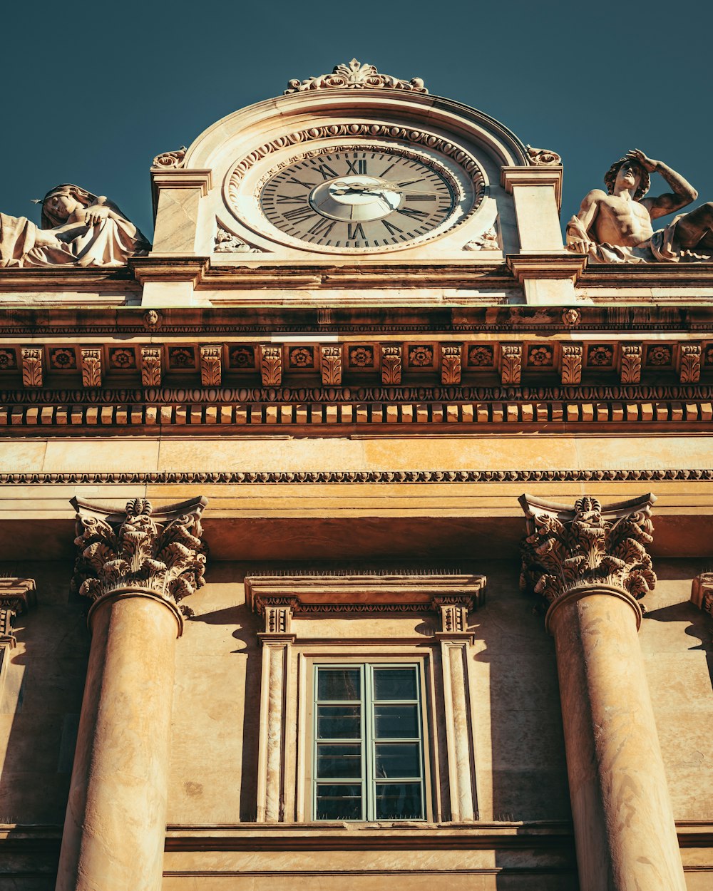 a clock on top of a building with columns