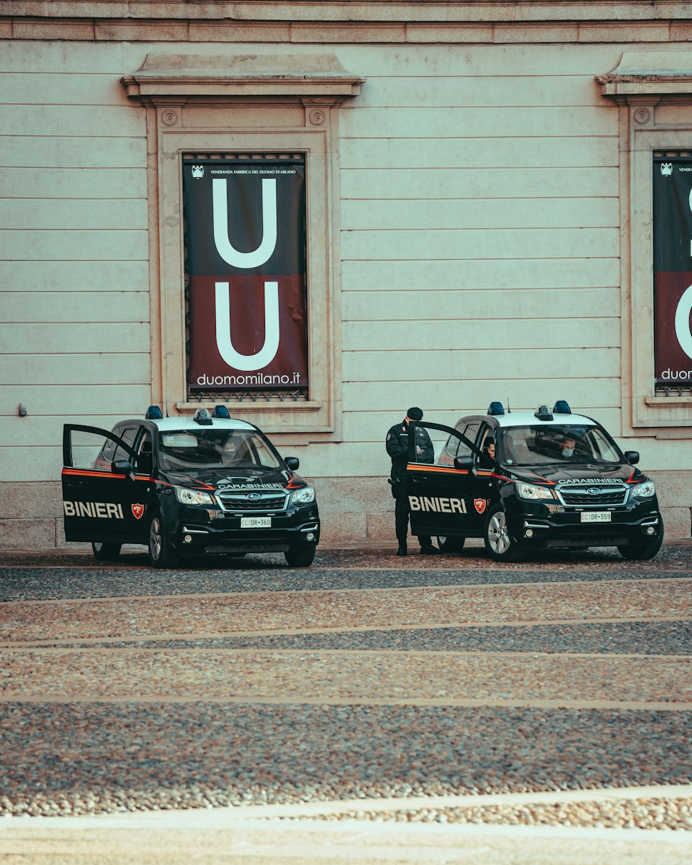 a couple of police cars parked next to each other