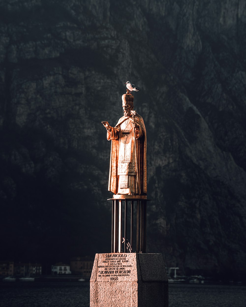 a statue of a man with a bird on his head