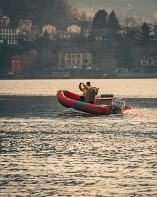 a man riding a boat on top of a body of water