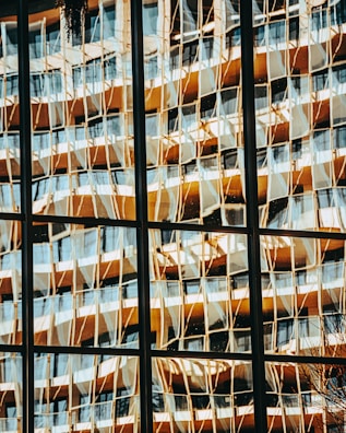 a reflection of a building in a window