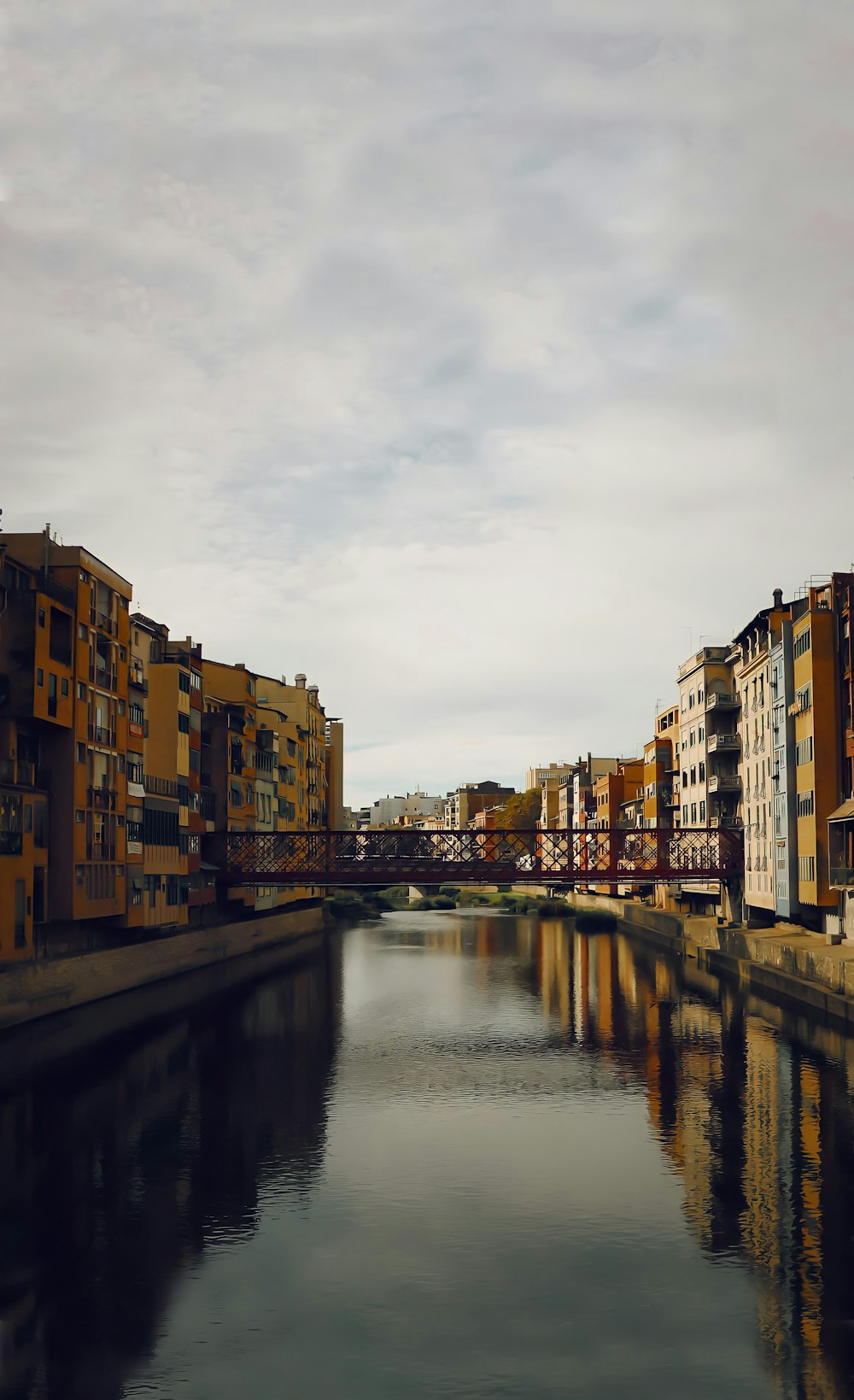 a river running through a city next to tall buildings