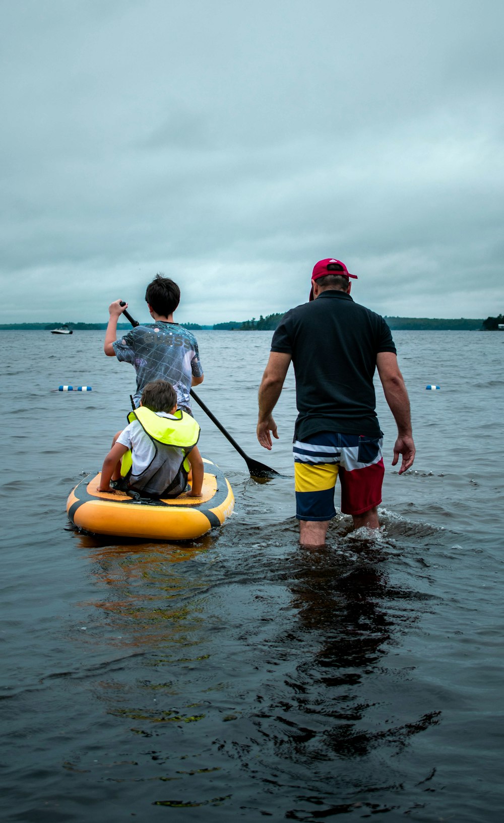 a man and a boy paddling a kayak in the water