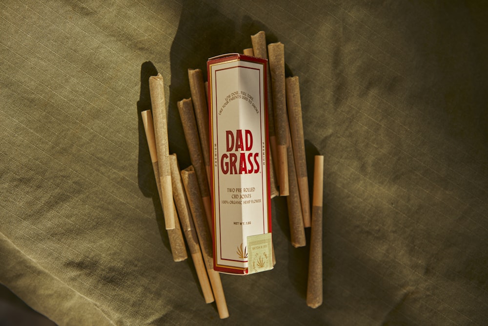 a box of cigars sitting on top of a bed