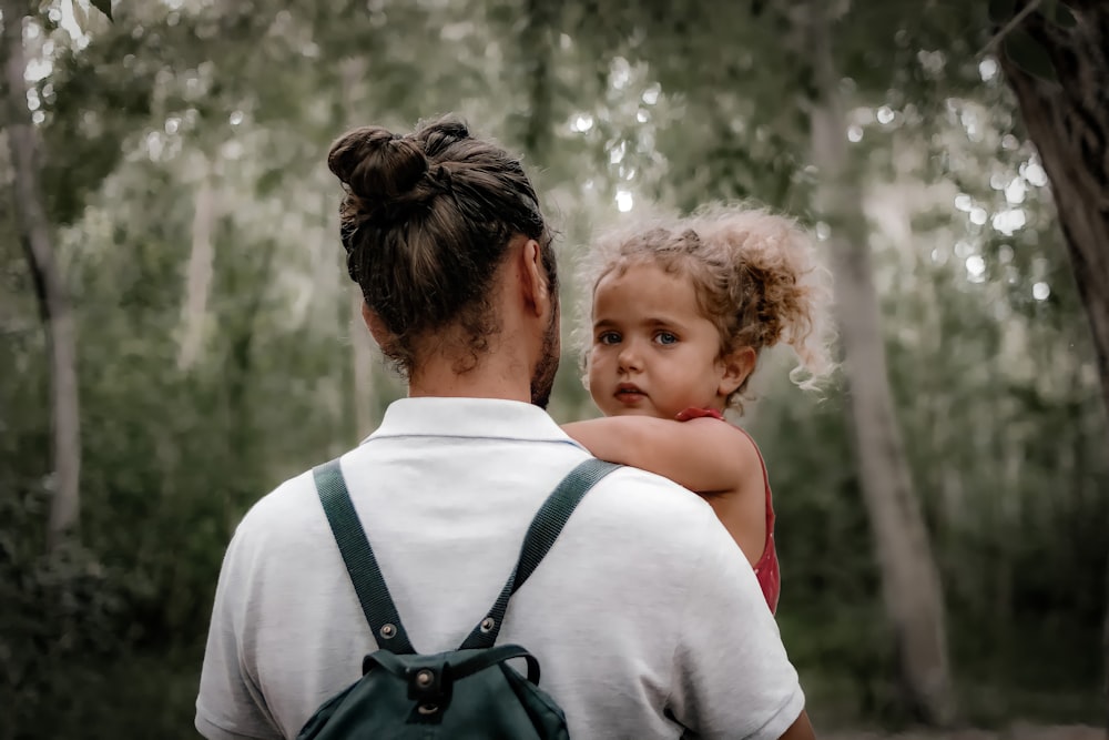 a man holding a little girl in his arms