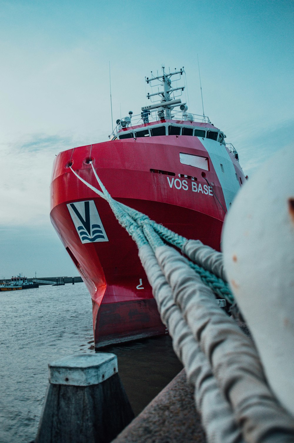 a large red boat docked at a pier