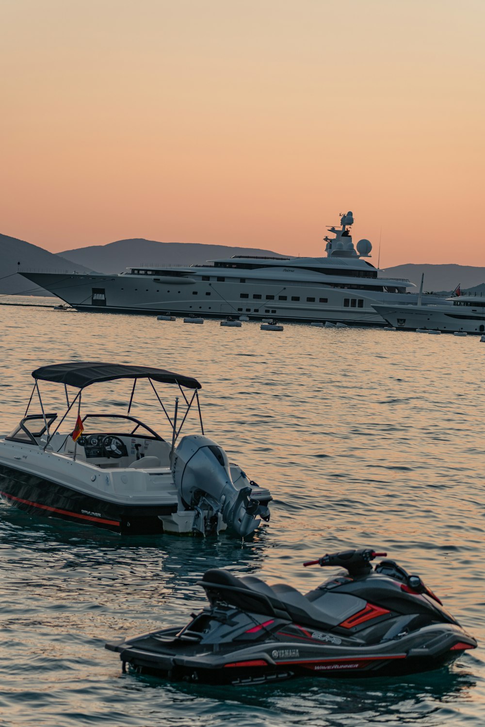 zwei Jetskis im Wasser mit einem Boot im Hintergrund