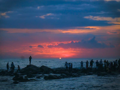 Sunset over the rugged coastline of Chubut with a small group of hikers admiring the view.
