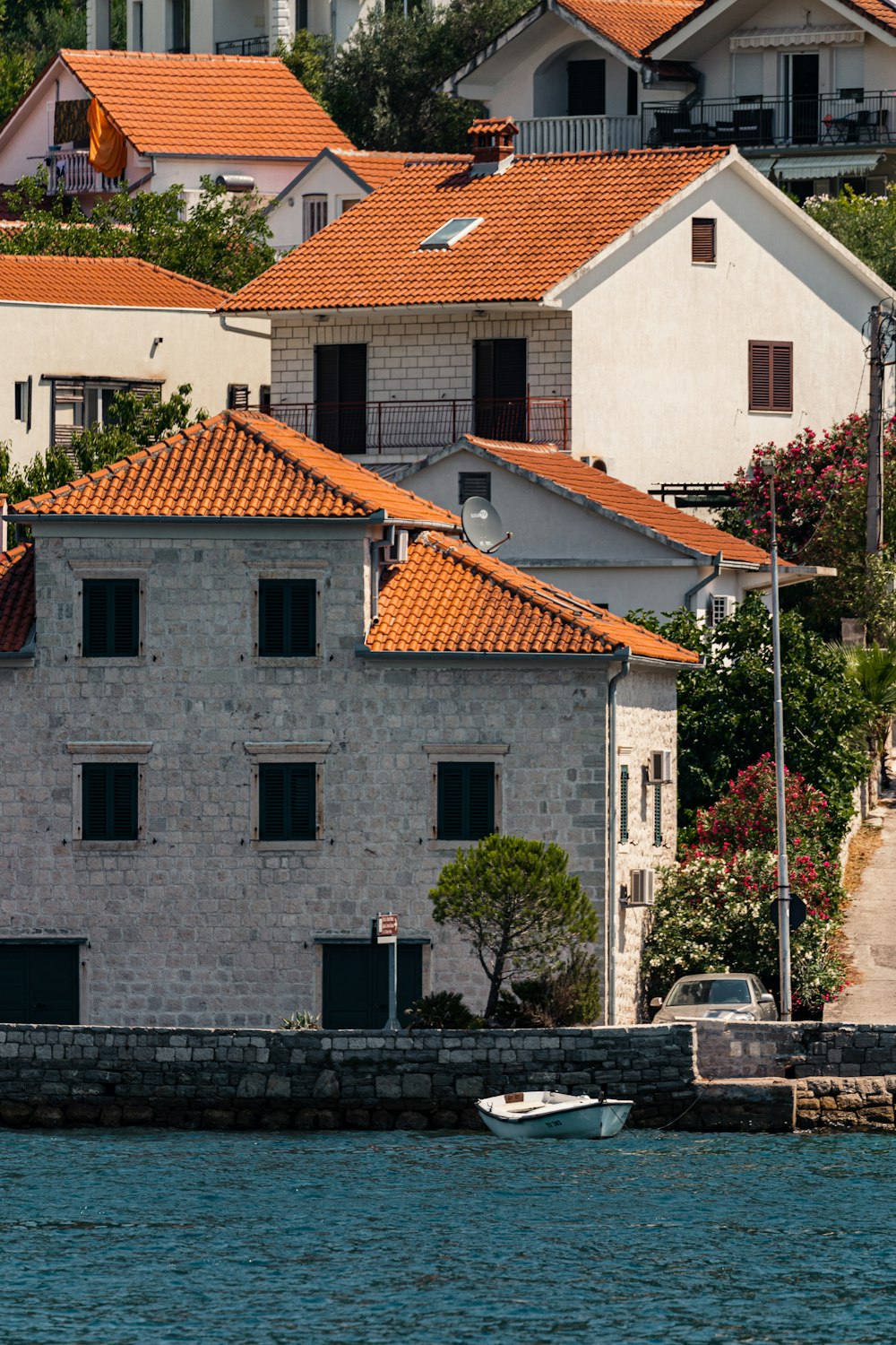 a row of houses next to a body of water