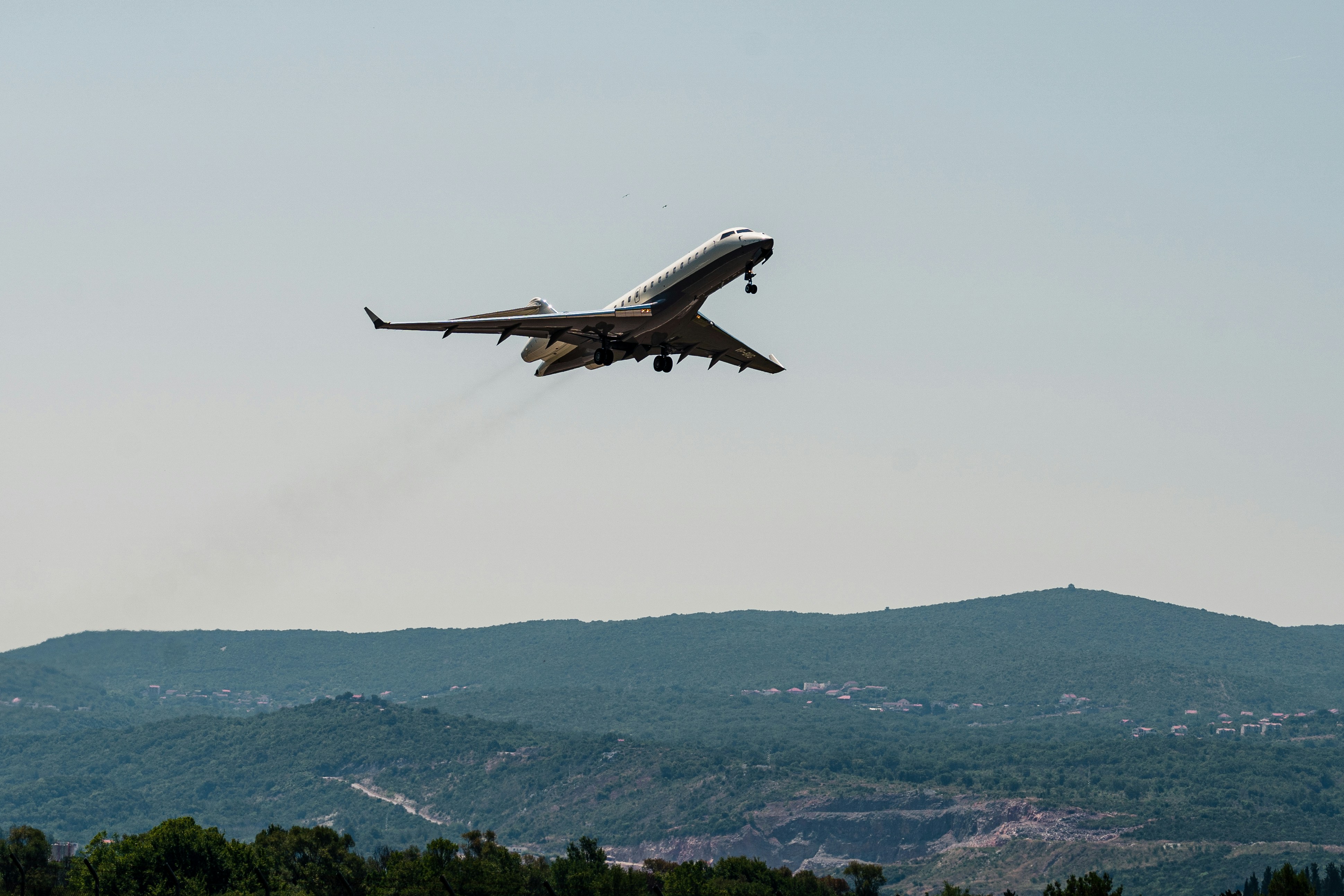 a large jetliner flying through a blue sky (Photo by Stefan Kostić on Unsplash)