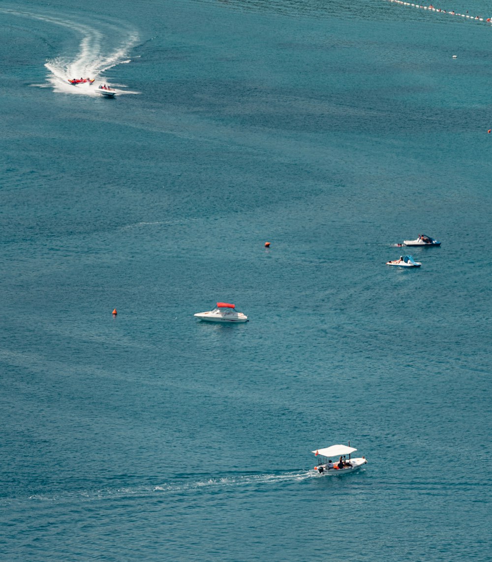 a group of boats floating on top of a large body of water