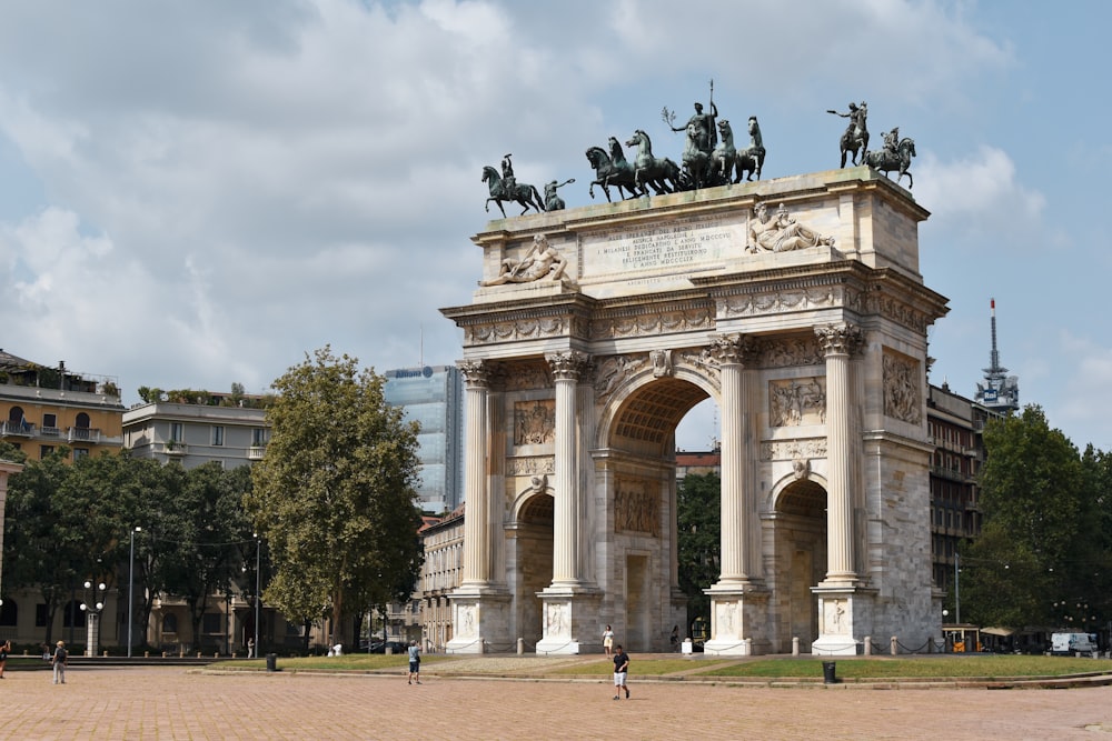 a stone arch with statues on top of it