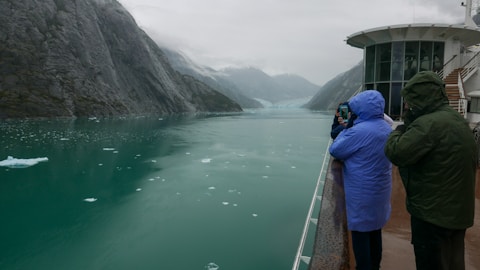 a couple of people that are standing on a boat