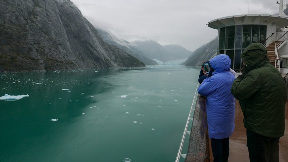 a couple of people that are standing on a boat