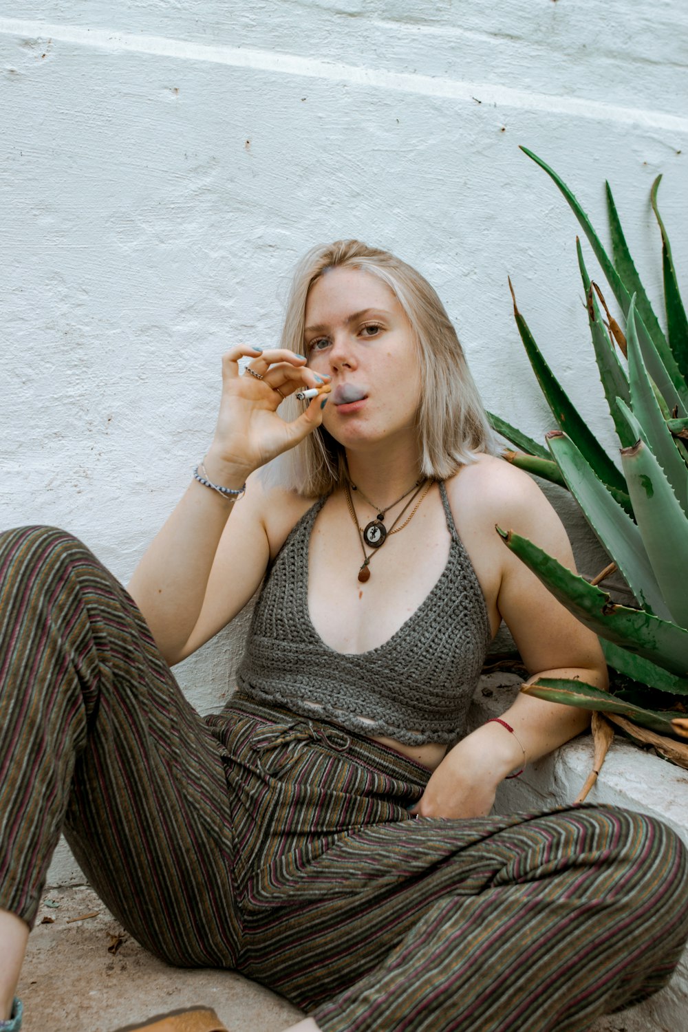 a woman sitting on the ground eating food